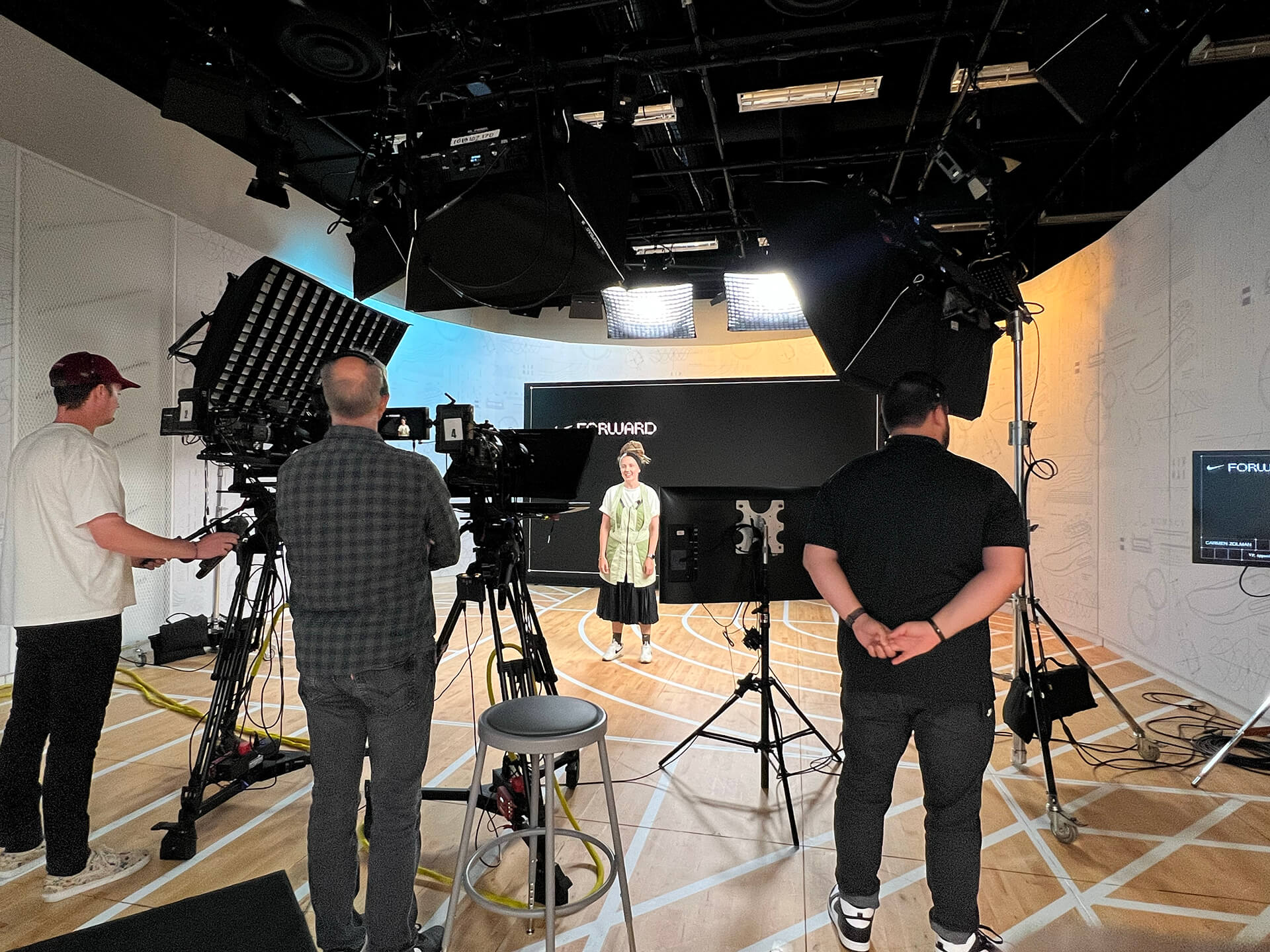 Camera crew filming a presenter on the Nike Forward webinar set at Nike World HQ