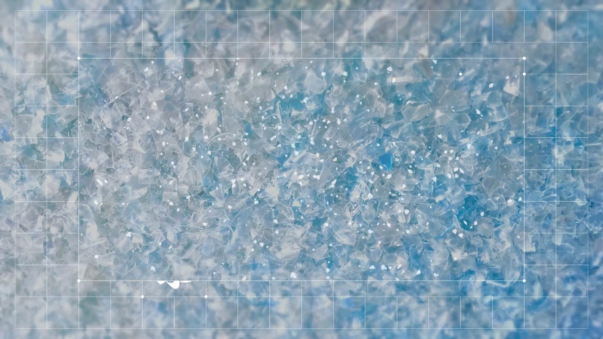 Close-up of recycled plastic flakes framed by the grid