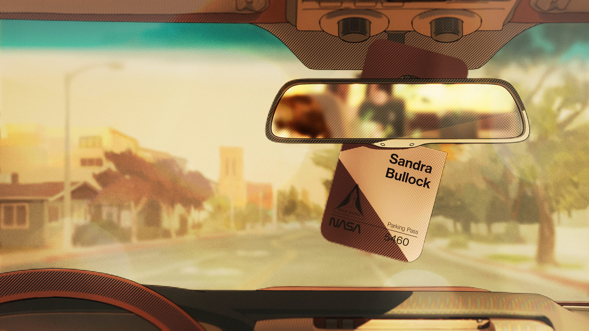 NASA parking pass for Sandra Bullock hanging from the rear-view mirror over a sunlit street