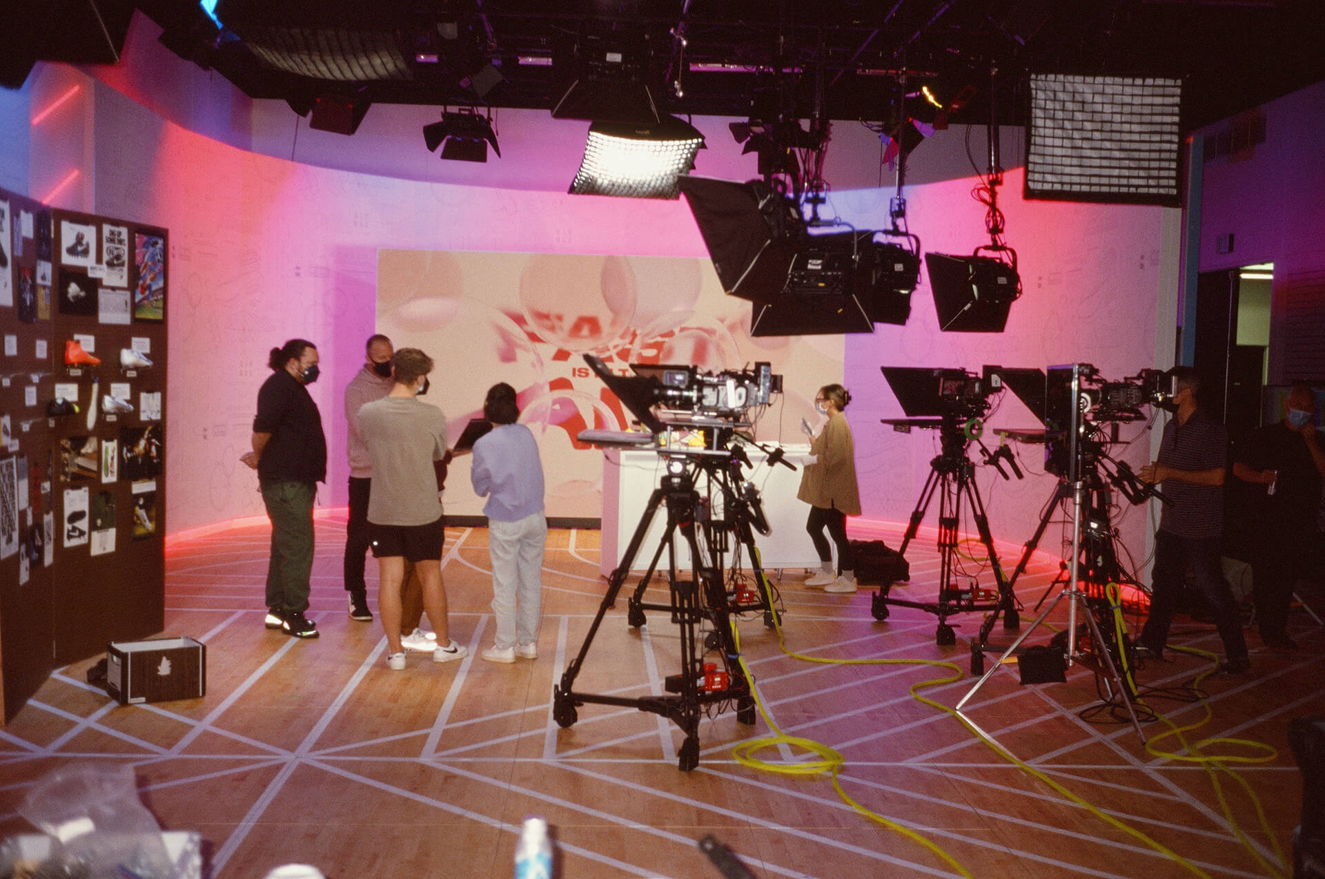 Broadcast set at Nike World HQ with cameras, teleprompters, and the heritage pin board
