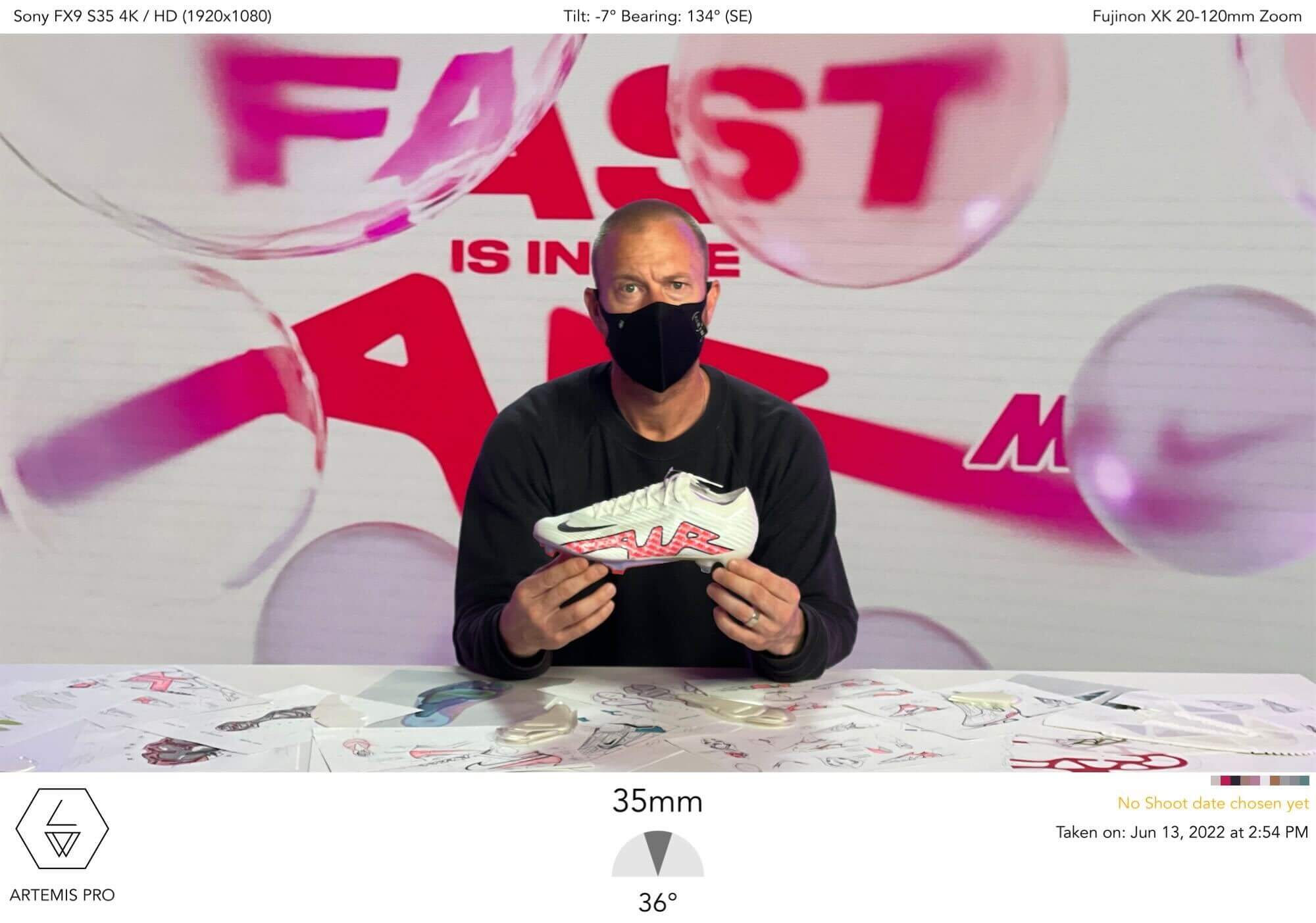 Designer presenting the new boot in front of the air bubble backdrop
